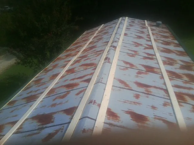 Rusted metal roof panels with new wood purlins before replacement — Storm Damage Roof Repair in Wausau by Roofing Brothers