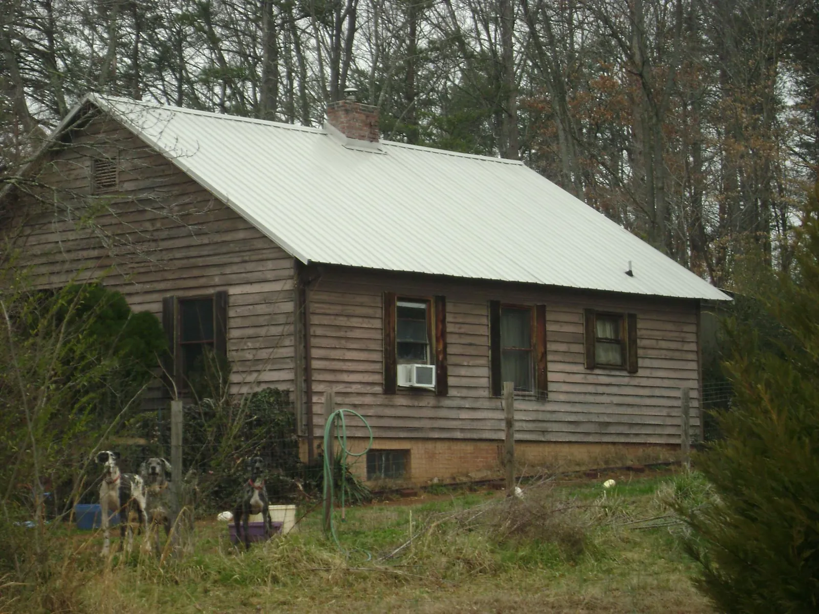 White metal roof on an old wood sided farmhouse, from a Metal Roof Installation job in Wausau